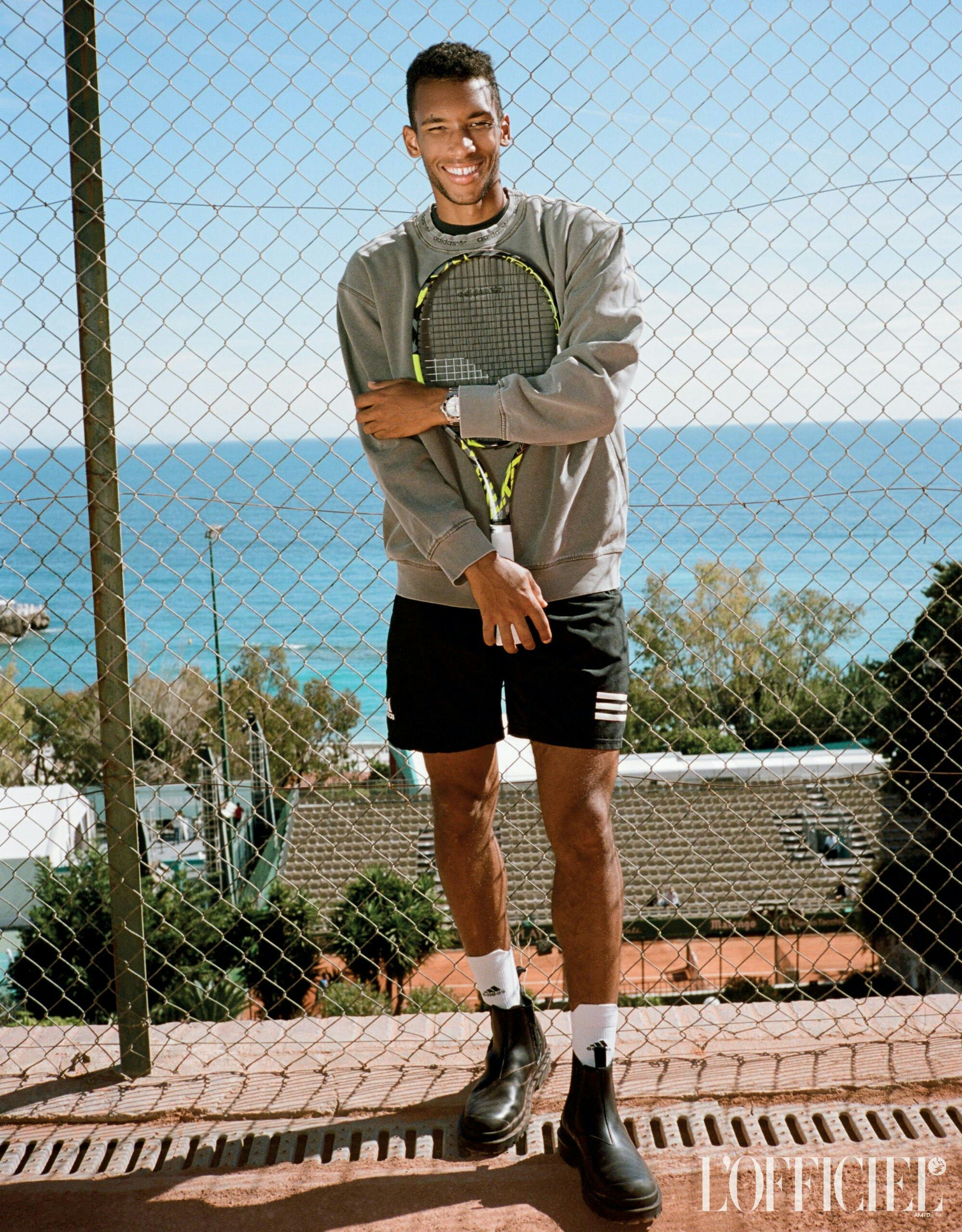 racket sport tennis tennis racket clothing shorts footwear shoe person sneaker